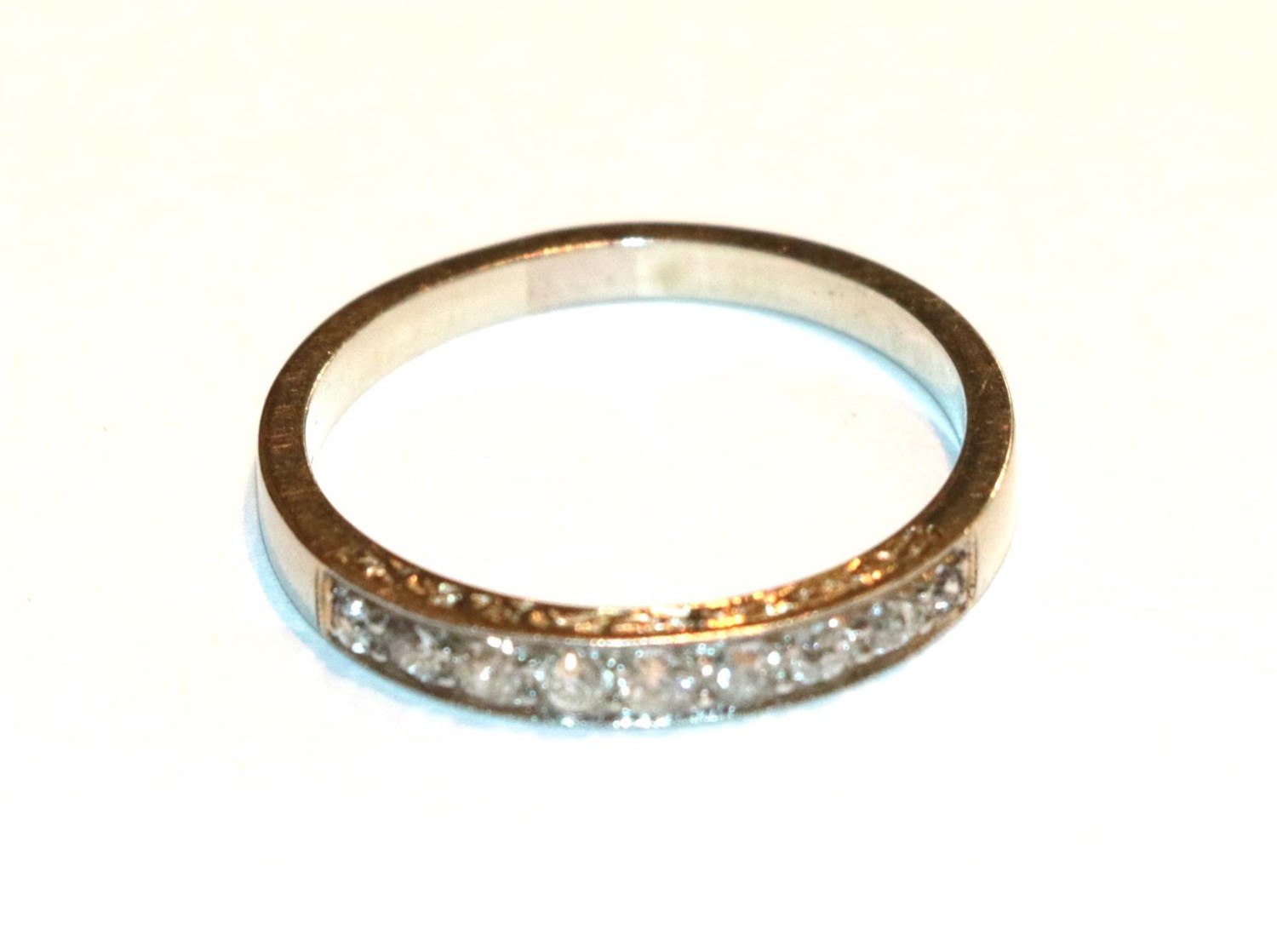 Lot 74 - A diamond quarter hoop ring, unmarked, finger size Q