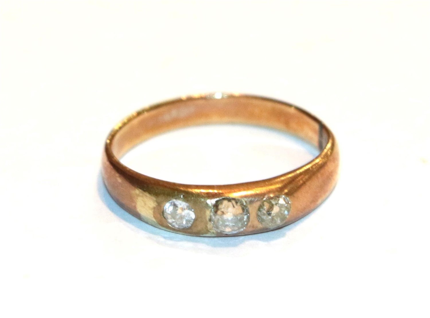 Lot 75 - A diamond three stone ring, unmarked, finger size L1/2
