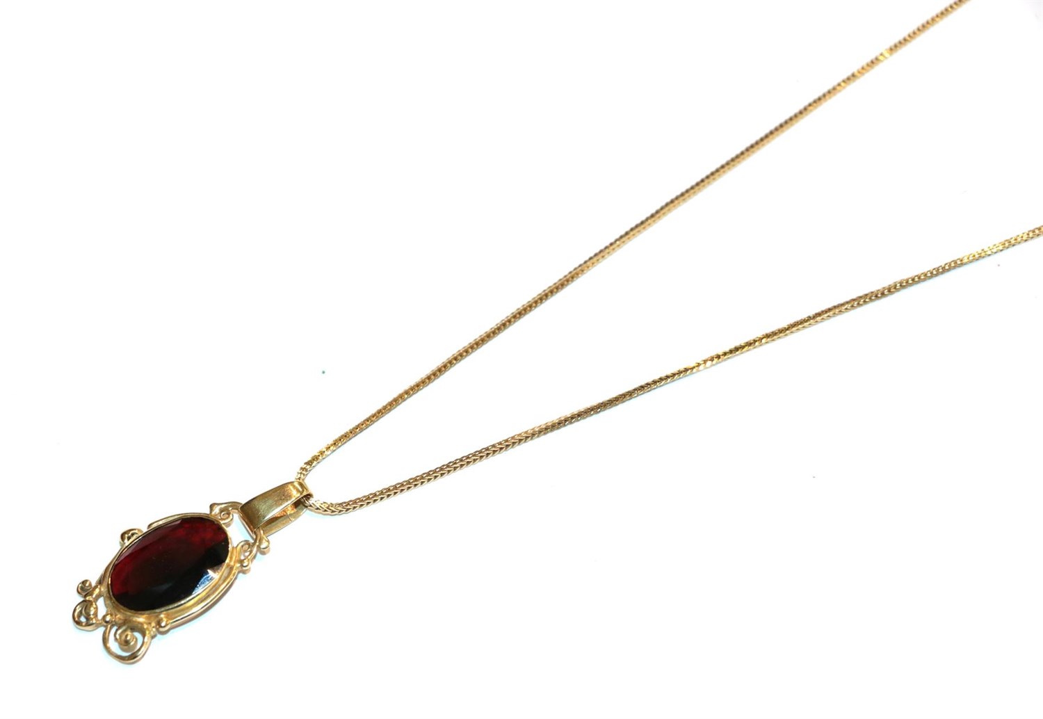 Lot 106 - A garnet pendant on a snake link chain, both stamped '750', pendant length 4.2cm, chain length...