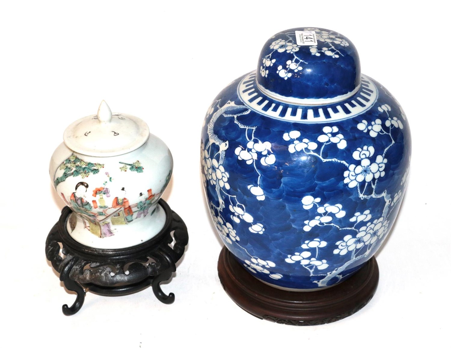Lot 141 - A Chinese prunus blossom ginger jar and cover and another ginger jar and cover, both on stands