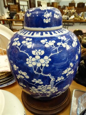 Lot 141 - A Chinese prunus blossom ginger jar and cover and another ginger jar and cover, both on stands