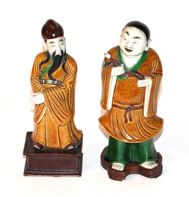 Lot 187 - Two Chinese biscuit porcelain figures, a boy with a lotus on a wooden stand and another of a...