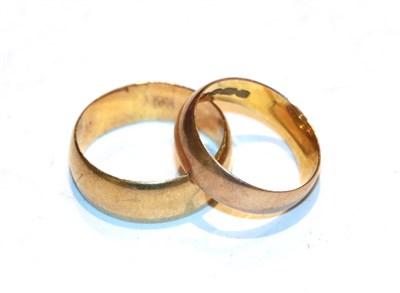 Lot 227 - A 12 carat gold band ring, finger size K; and a band ring, stamped '18K', finger size N1/2