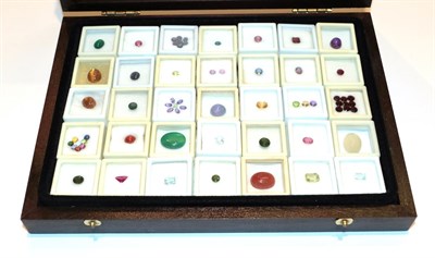 Lot 243 - A collection of thirty-five various round cut and cabochon gemstones including agates,...