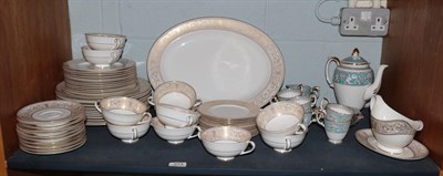 Lot 274 - Royal Doulton Gold Sovereign dinner service comprising an oval dish, sauceboat with stand,...