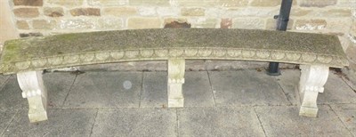 Lot 1139 - A Natural Stone Curved Garden Seat, of recent date, the gadrooned seat in two sections, above three