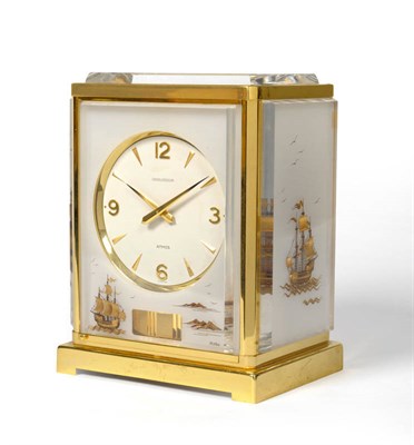 Lot 1157 - An Unusual Gilt Brass Atmos Clock with Plexi Panels Depicting Galleons, signed Jaeger...