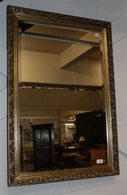 Lot 1249 - A reproduction gilt bevel glass mirror, 96cm by 66cm