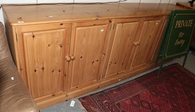 Lot 1252 - A large six-door pine cupboard, 292cm by 54cm by 100cm