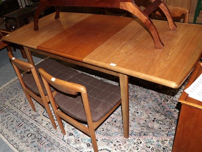 Lot 1257 - A teak extending dining table, with one additional leaf, 182cm (extended) by 84cm by 75cm; and...