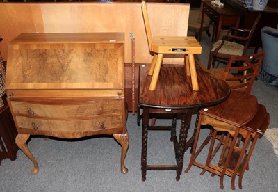 Lot 1260 - A 1930's figured walnut bureau; an early 20th century oak drop-leaf table; a nest of three...