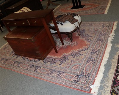 Lot 1261 - A machine made carpet the field with central medallion framed by indigo borders, 397cm by...