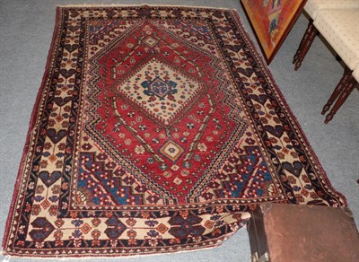 Lot 1272 - A Kashgai rug, the strawberry field centred by a hut medallion, framed by ivory bordered, 206...