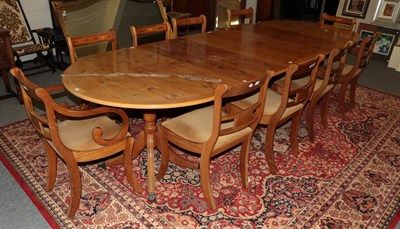 Lot 1296 - A Regency style yew wood extending dining table with three leaves, supported by three...