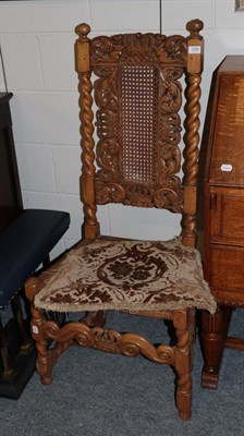 Lot 1299 - A 17th century style hall chair with carved top rail, cane back and seat