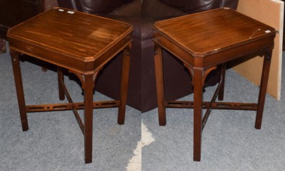 Lot 1316 - A pair of reproduction Chippendale style mahogany lamp tables, label attached to underside made...