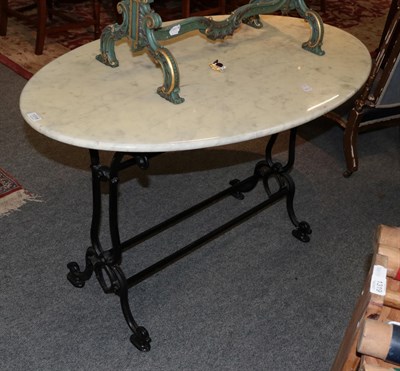 Lot 1318 - A white marble oval table with black metal scrolled base