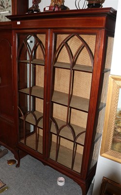 Lot 1336 - An Edwardian mahogany display cabinet with lancet arched glazed doors