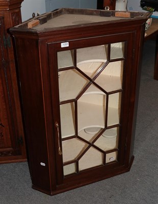 Lot 1354 - An early 19th century mahogany corner cupboard