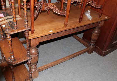 Lot 1357 - A carved oak refectory table with turned bulbous legs, joined by an H-stretcher, 137cm by 90cm...