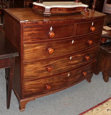 Lot 1374 - A late George III mahogany and crossbanded bow-fronted chest, 116cm by 56cm by 106cm high