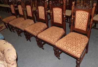 Lot 1394 - A set of six late Victorian carved oak and upholstered dining chairs