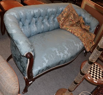 Lot 1400 - A Victorian mahogany two-seater sofa, upholstered in blue buttoned fabric