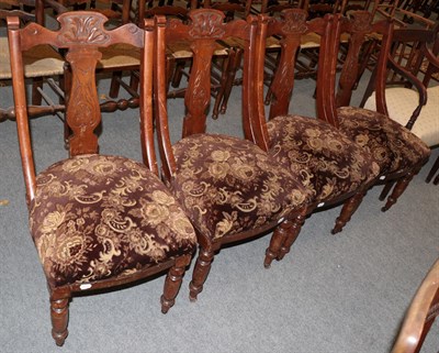 Lot 1405 - A set of four Victorian carved walnut dining chairs with over-stuffed seats