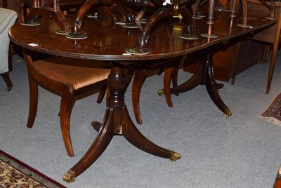 Lot 1419 - A Regency style mahogany twin-pedestal dining table, with additional leaf