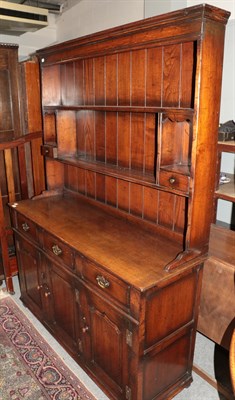 Lot 1437 - A reproduction oak Welsh dresser, 138cm by 46cm by 187cm high