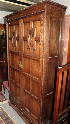 Lot 1438 - An early 20th century carved oak Jacobean style double-door wardrobe