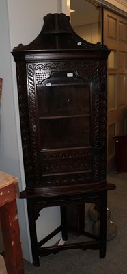 Lot 1445 - An 18th century carved oak glazed corner cupboard on stand, 67cm by 40cm by 207cm high