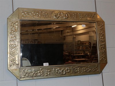 Lot 1446 - A brass Arts & Crafts style bevel mirror; together with an English school (19th/20th century)...