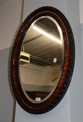 Lot 1447 - A mahogany oval mirror, 87cm by 62cm