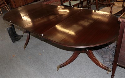 Lot 1460 - A Regency style mahogany twin-pedestal extending dining table, with two additional leaves,...