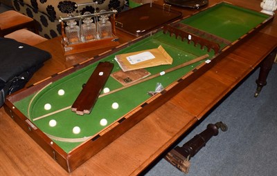 Lot 1462 - A 19th century mahogany folding bar bagatelle table with two cues and nine balls