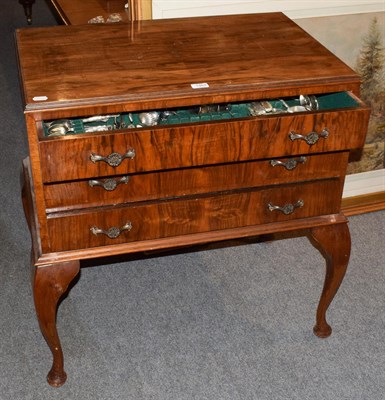 Lot 1464 - A 1920's three drawer canteen table, 84cm by 54cm by 85cm high, containing a mixture of King's...