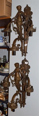 Lot 1467 - A pair of reproduction three-light figural wall sconces