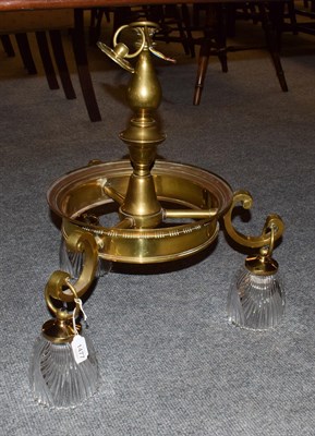 Lot 1477 - A brass three light electrolier with heavy slice cut glass shades