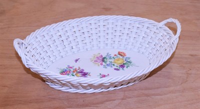Lot 143 - A 20th century Meissen porcelain basket, with twin handles and painted with floral sprays, 25cm...