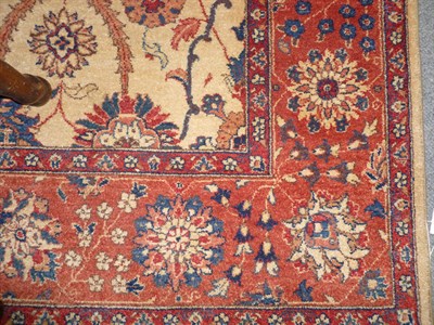 Lot 1233 - Pakistan Wool Carpet The fawn ground worked with rows of stylised floral medallions within a...