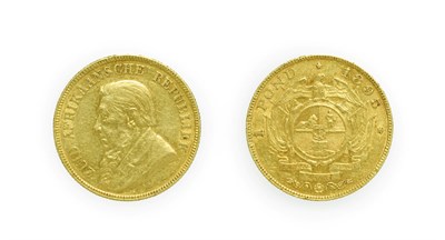 Lot 4258 - South Africa, Paul Kruger, 1895 Pond. Obv: Bust left. Rev: Circular shield of arms, wagon with...