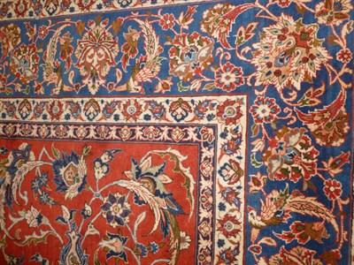 Lot 1243 - Isfahan Carpet Central Persia The tomato field with an allover design of palmettes and...