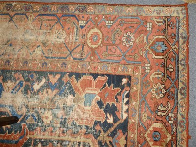 Lot 1244 - Heriz Carpet Persian Azerbaijan The indigo field with a salmon pink pole medallion surrounded...