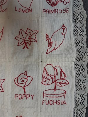 Lot 6038 - Early 20th Century Embroidered Cot Cover, worked in squares of cotton and embroidered in red...