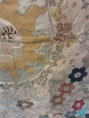 Lot 6046 - A Late 18th Century Silk Patchwork Bed Cover, with a central roundel enclosing a stylised...