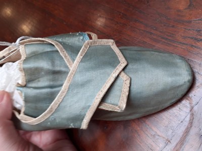 Lot 6065 - A Mid 18th Century Pale Blue Silk Single Shoe, with natural linen lining, cream silk trim and...