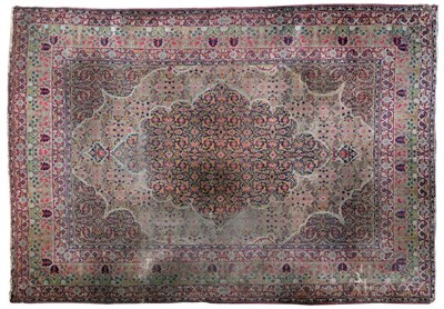 Lot 1255 - Kirman Carpet South East Persia The ivory field of scrolling vines around an indigo Herati...