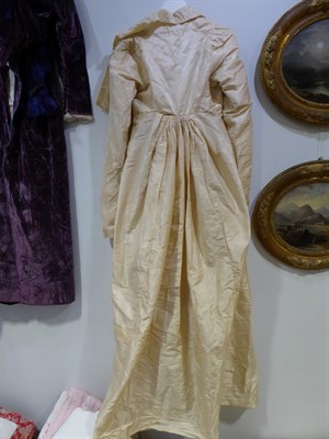 Lot 6113 - A Circa 1790 English Cream Silk Round Gown, with long sleeves, buttoned bodice with collar and full