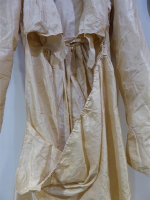 Lot 6113 - A Circa 1790 English Cream Silk Round Gown, with long sleeves, buttoned bodice with collar and full